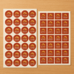 High-resolution mockup of printed label stickers on sheets for commercial product packaging use.